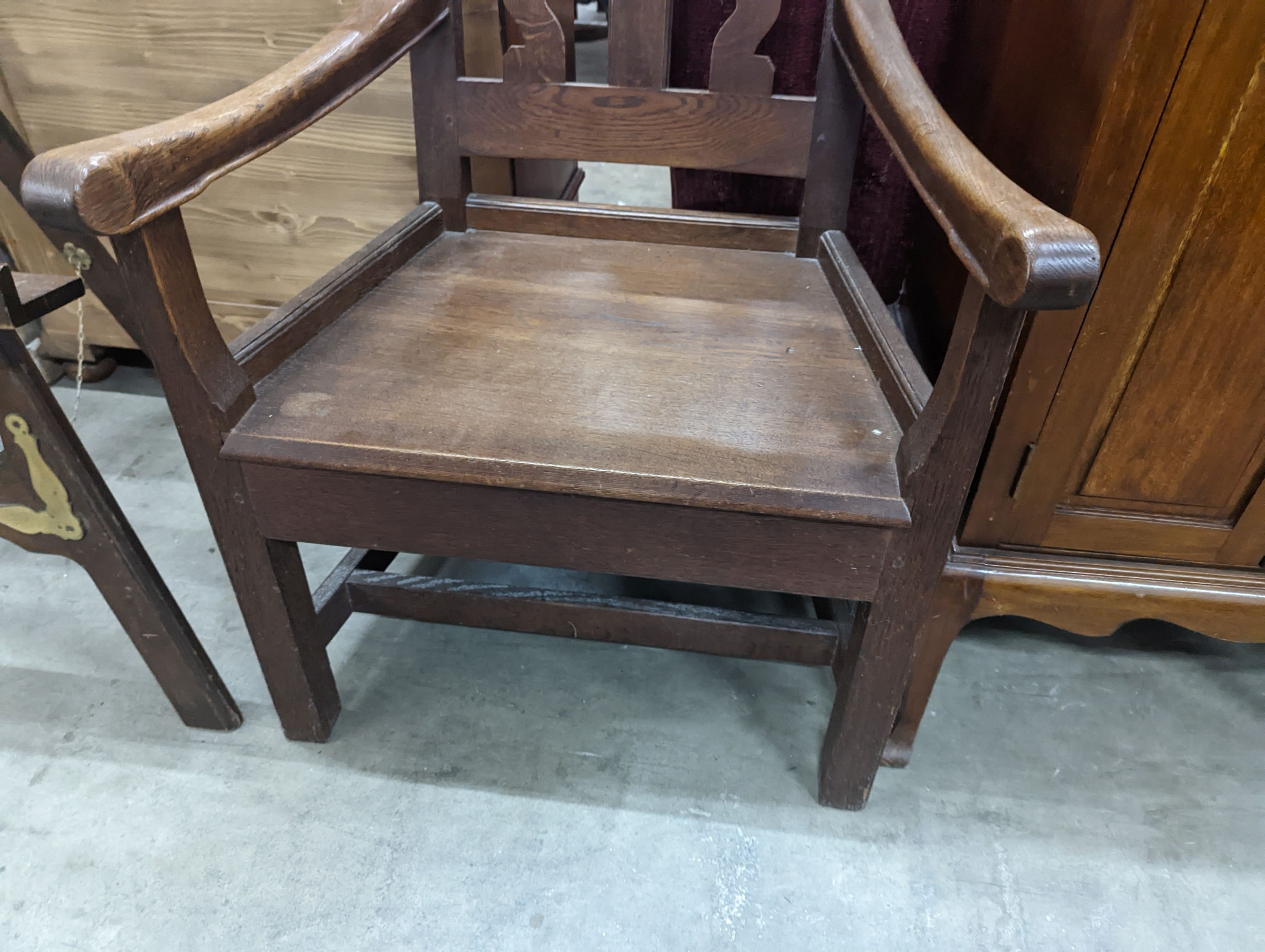 An Arts and Crafts elbow chair, width 61cm, depth 45cm, height 106cm